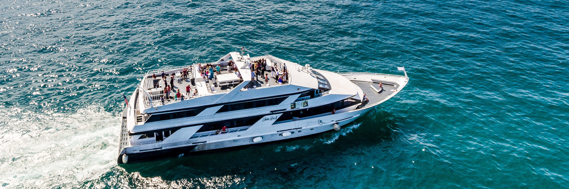 Chicago private yacht charter Anita Dee II on blue-green water.